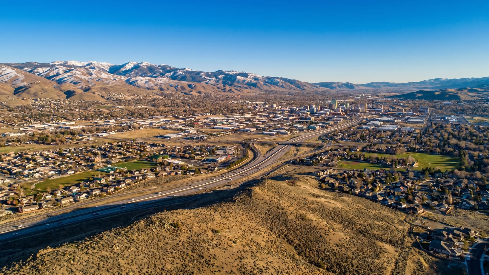 Aerial of the Reno-Sparks Truckee Meadows valley ringed by mountains
